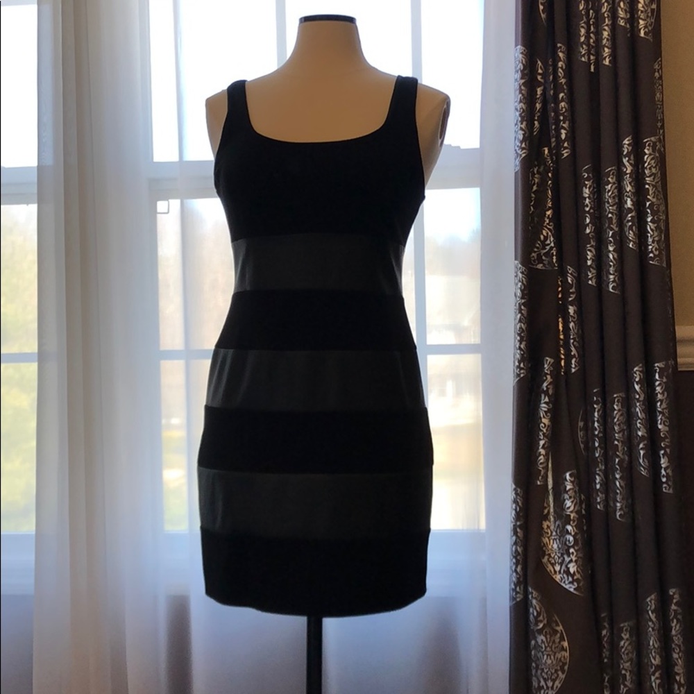 Black dress with faux leather inserts.